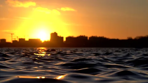 Slow-Motion water ripples during sunset Stock Footage 209851144