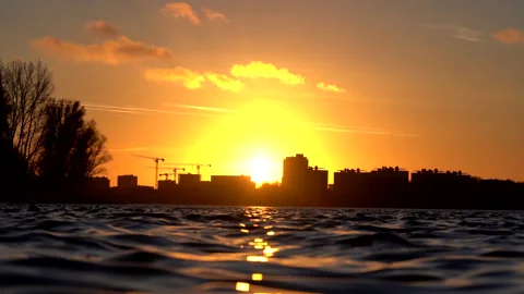 Slow-Motion water ripples during sunset Stock Footage 209853695