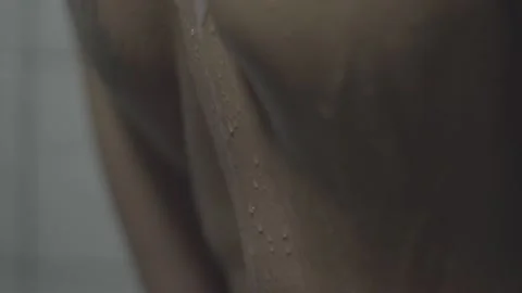 Slow motion water running down womans back in the shower. s-log prores 4444 Stock Footage 236435133