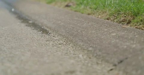 Slow Motion Water Running Down Street Gutter Stock Footage 243396139