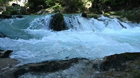 Slow motion of water running over rocks of a mountain stream Stock-Footage 260868519