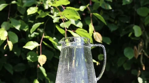 Slow Motion of Water Splash from Full Glass Pitcher Stock Footage 136623604
