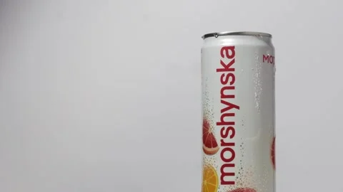 Slow motion of water splash over Morshynska orange flavored drink can Stock Footage 242419926