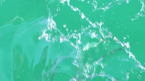 Slow motion of water splashing with drops on green screen chroma key background Stock Footage 247488199