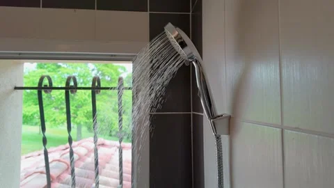 Slow Motion Water Spraying from Chrome Shower Head in Bathroom Stock Footage 336225879