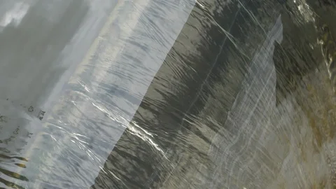 Slow motion, water stream flowing in floodgate of small dam Stock Footage 113399105