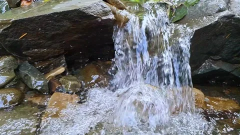 Slow motion of water stream flowing in the mountains over rocks Stock Footage 160888563