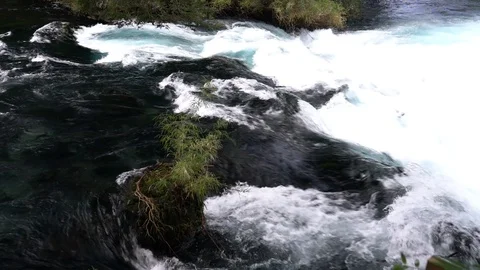 Slow motion water stream movement at Patagonia river inside rainforest Stockbeeldmateriaal 117222833