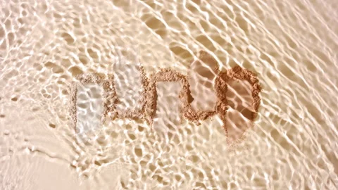 Slow motion water stream over beige powder smears Stock Footage 340503455