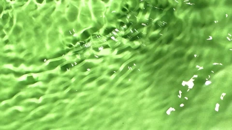 Slow motion water surface texture splashes, ripples isolated on green background Stock Footage 165854746