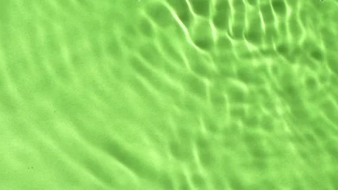 Slow motion water surface texture splashes, ripples isolated on green background Stock Footage 168050076