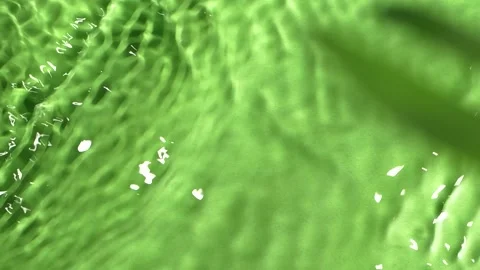 Slow motion water surface texture splashes, ripples isolated on green background Vídeos de archivo 169679046