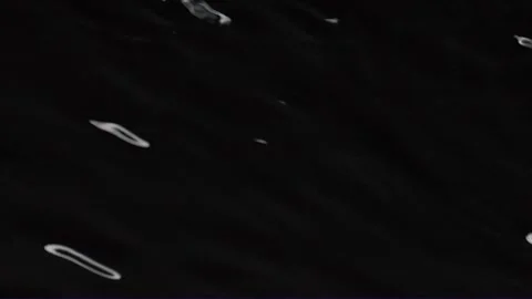 Slow motion water surface texture splash, waves and ripples on black background Video stock 247949824