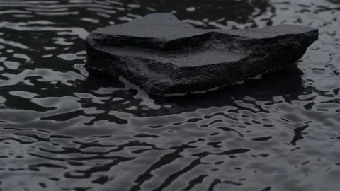 Slow motion water surface texture splashes, waves and ripples with black stone Vídeo Stock 253371895