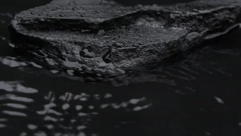 Slow motion water surface texture splashes, waves and ripples with black stone Vídeos de archivo 283712922