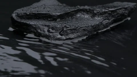Slow motion water surface texture splashes, waves and ripples with black stone Vídeo Stock 286947535