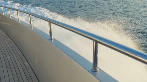 SLOW motion, Water wave splashes behind of fast moving motor yacht boat. Video stock 92354419