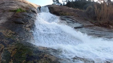 Slow motion of a waterfall and raindrops in a spectacular landscape Stock Footage 124610064