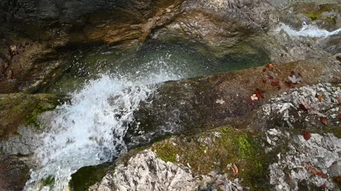 Slow motion of a waterfall and rocks in autumn Video stock 260864041
