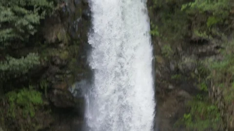 Slow motion waterfall crashing - Flowing Texture and Lush Vegetation Stock Footage 339564711