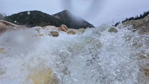 Slow Motion Waterfall Flowing Between Rocks with Mountain View 스톡 동영상 305236267