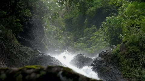 Slow motion waterfall flowing fast in the middle of the forest Stock Footage 297634471
