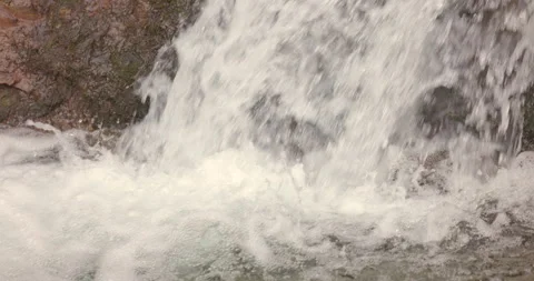 Slow Motion Waterfall Flowing Over Rocks in Nature Stock Footage 302963540