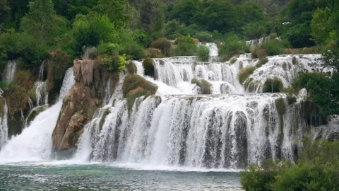 Slow motion waterfall landscape video natural lake in the middle of the forest Stock Footage 253522264