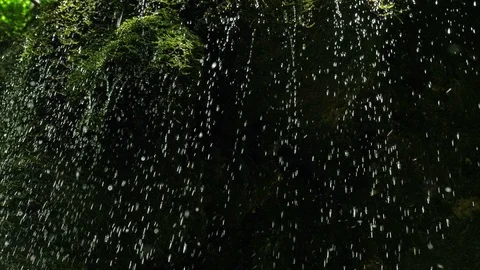 SLOW motion, waterfall in mountains. Closeup water drops falls splashing on moss Stock-Footage 92696391