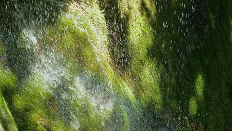 SLOW motion, waterfall in mountains. Closeup water drops falls splashing on moss 스톡 동영상 92703025