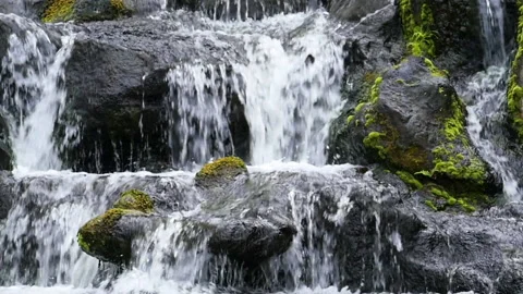 Slow motion waterfall over dark rocks Stock Footage 137663203