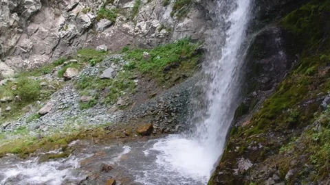 Slow Motion Waterfall Over Mossy Rocks in Kyrgyz Mountain Terrain Stock Footage 306607049