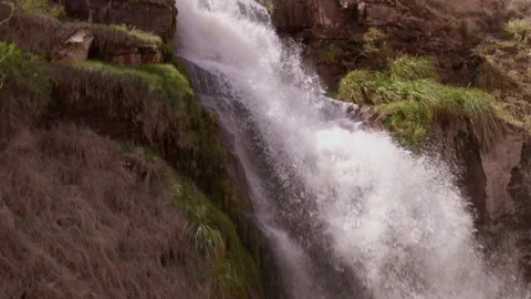Slow motion waterfall rainbow close-up on desert oasis. Mollesaja Waterfall Stock Footage 306005619
