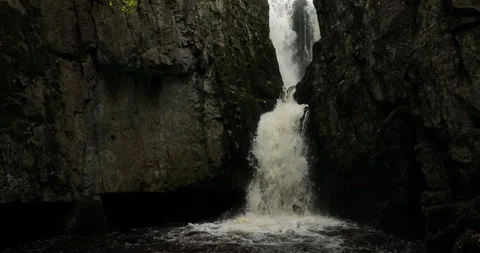 Slow motion of waterfall in a rocky gorge Stock Footage 220173387