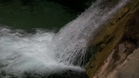 Slow Motion Waterfall Splashing Over Mossy Rock Detail Stock Footage 335758719