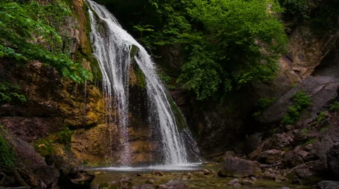Slow motion of waterfall in subtropical forest. Small river falling from stones Video stock 43338101