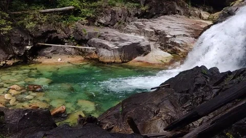 Slow Motion Waterfall Into Vibrant Pool Stock Footage 168905988