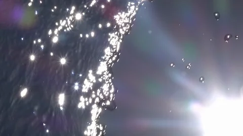 Slow motion of waterfall wall with shining sun in corner and playing lens flare. Stock Footage 100237242