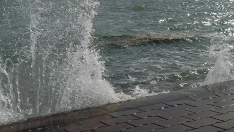 Slow motion wave breaking against a sea wall in Southsea. Stock Footage 161029501