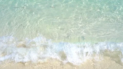 Slow motion of wave breaking, crystal clear blue sea in bright sunlight Stock Footage 106368204