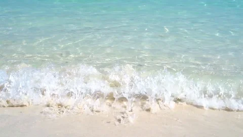 Slow motion of wave breaking, crystal clear blue sea in bright sunlight Stock Footage 106368206