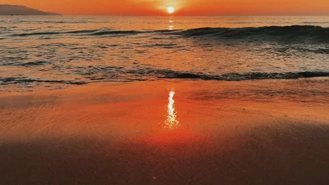 Slow motion of the wave breaks on the sand during Amazing Romantic red sunrise 스톡 동영상 343595132
