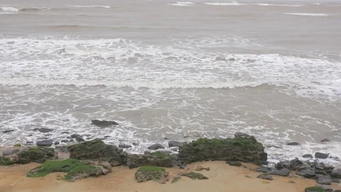 Slow motion wave crash into rocks Stock Footage 85319249