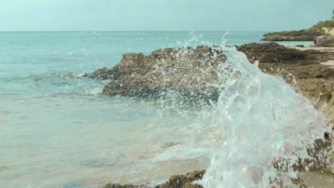 Slow motion wave crash splash wave close up crashing on rocks wave splashing Stock Footage 304470054