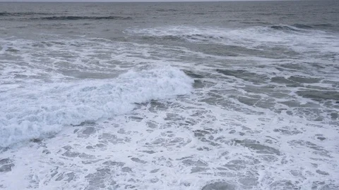 Slow-motion wave crashes as camera pulls backwards Stock Footage 112703991