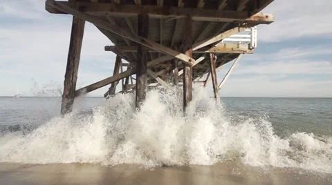 Slow Motion Wave Crashing Under Pier. Stock Footage 50000105