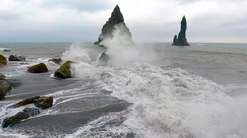 Slow motion of wave impact over a rock in the seashore of Iceland. Stock Footage 296063958
