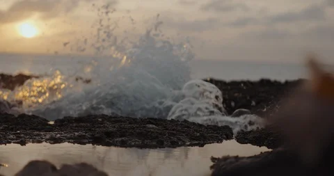 Slow motion wave on rock splash at sunset with Stock-Footage 96773966