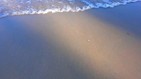 Slow motion wave sea on sand beach on sunset beauty Stockbeeldmateriaal 83605213