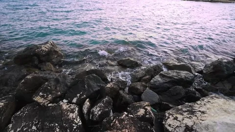 Slow motion wave splashing over seaside rocks Stock Footage 316543916